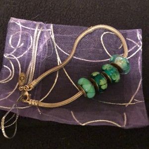 Pandora bracelet with 4 peacock color beads.